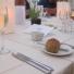 Candles and place setting in The Orangery Alderney