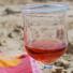 Glass of rose wine on the beach, pink towel, Alderney